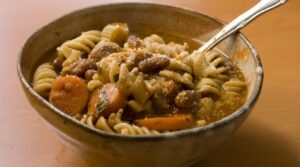 Steaming bowl of hearty classic Italian minestrone soup with tender vegetables and pasta