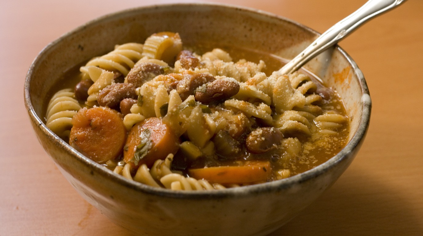 Steaming bowl of hearty classic Italian minestrone soup with tender vegetables and pasta
