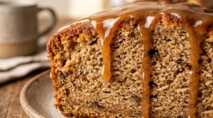 Ultra close-up macro texture of moist spiced apple cider pound cake drenched in glossy cider glaze
